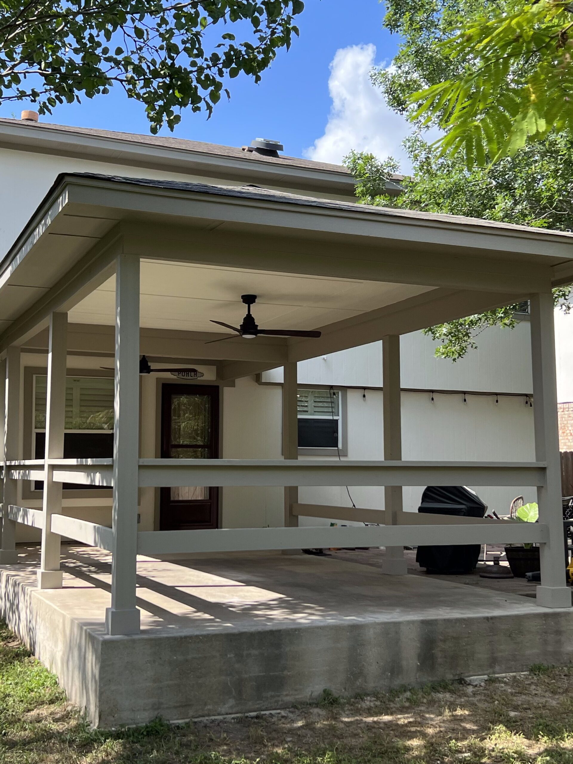 Manchaca patio addition with covered patio, exterior carpentry, railing, and concrete slab