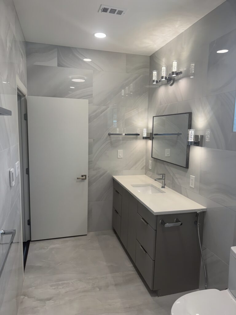 Driftwood Hays County master bathroom remodel with shower tile, bathtub, glass enclosure, and updated finishes