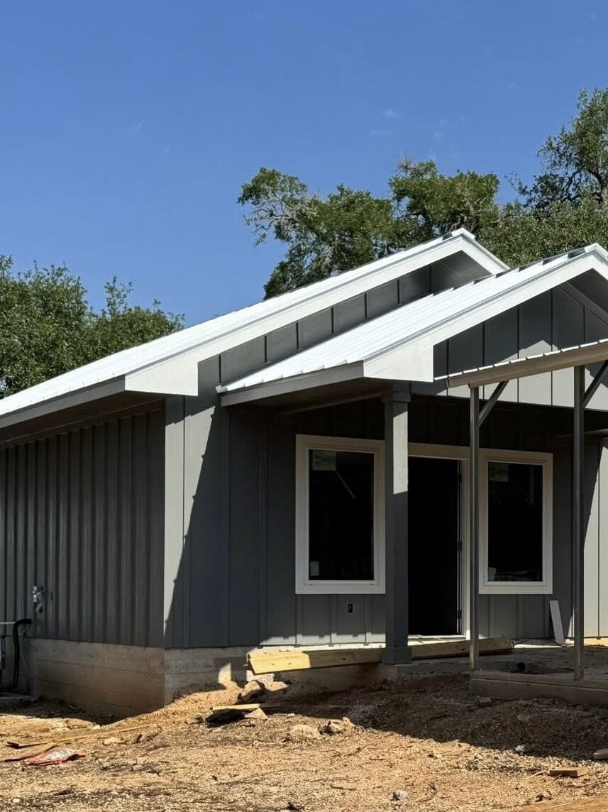 Driftwood small custom home build with concrete pour, framing, carport, and rainwater collection system
