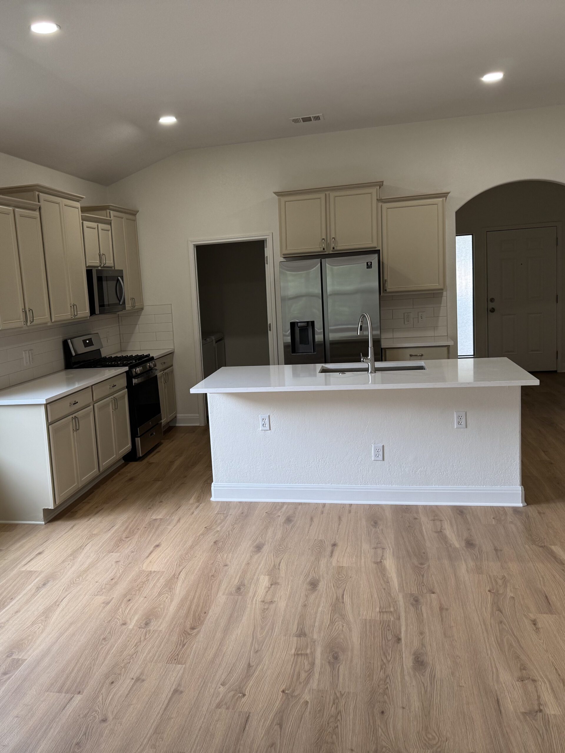 Kyle interior home remodel with flooring, kitchen lighting, cabinet painting, countertops, and interior paint